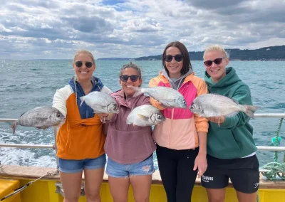 Group of girls fishing in Lyme Regis